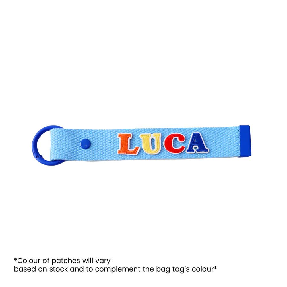 Le Petit Society's customisable blue bag tag with name patches.