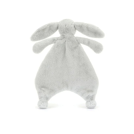 A back view of a silver plush bunny comforter with long floppy ears, stitched facial features, and a flat blanket-style body with lightly padded arms and feet, positioned standing against a white background.
