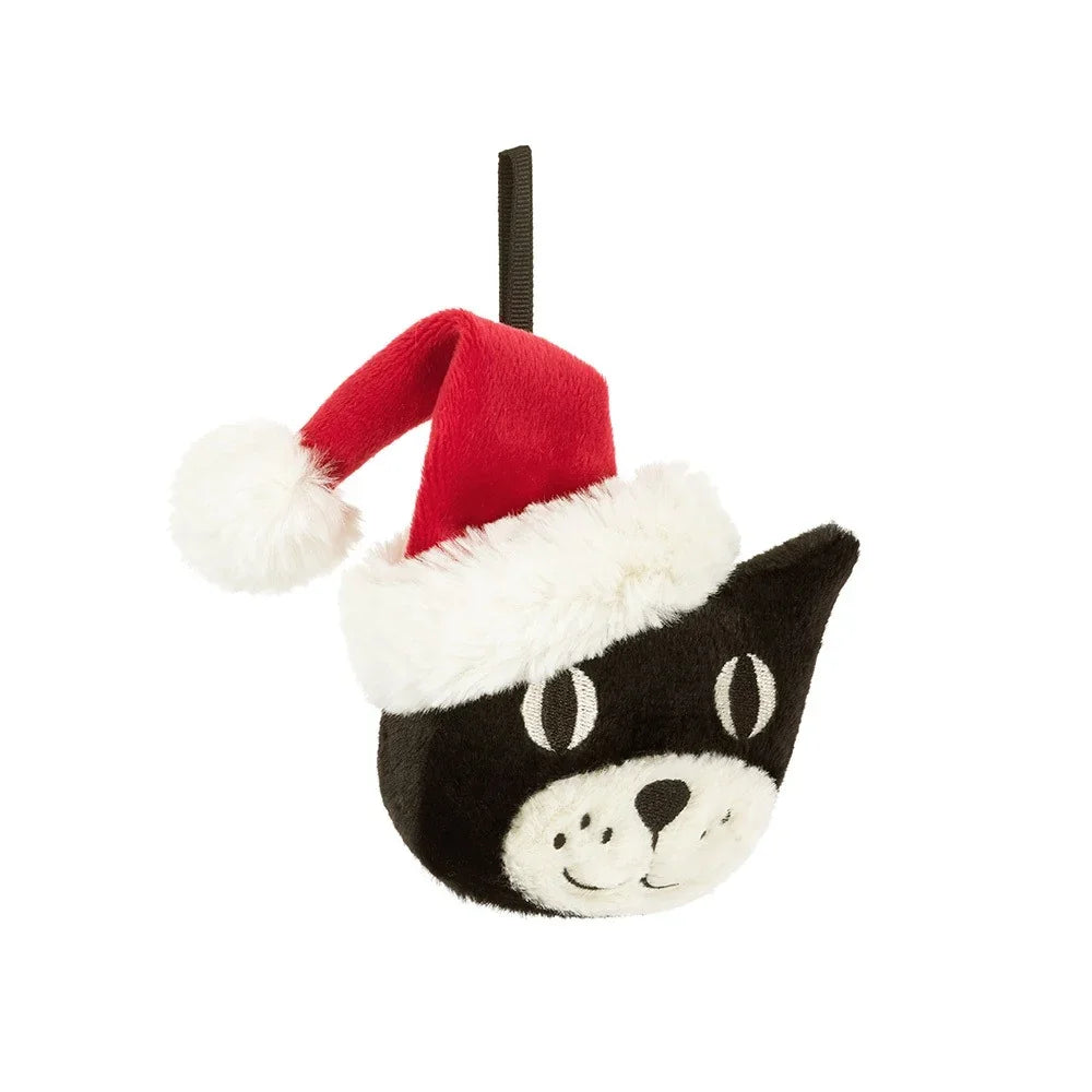 A 45-degree view of a plush black cat ornament wearing a red Santa hat with white fur trim and pom-pom, hanging from a black ribbon loop, displayed against a white background.
