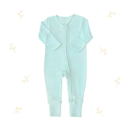An organic baby zip sleepsuit from Le Petit Society. It is mint blue in colour, with a print of leaves and foldable mittens and footies.