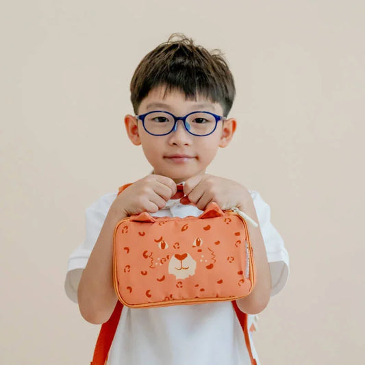 A kindergartener with an orange Explorer pencil case and pouch in leopard print.