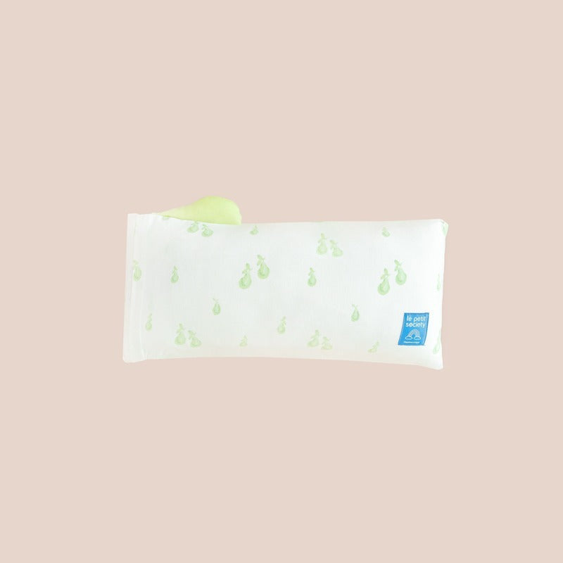 The back of a kids' mini pillow from Le Petit Society, featuring a print of green pears.