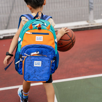 A primary school carrying the LPS kids single pocket school bag and lunch bag set in dinosaur.