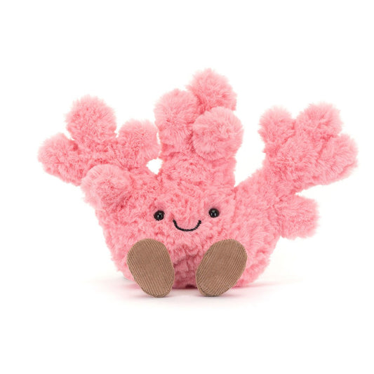 A front view of a soft pink plush coral toy  with textured branches, a happy stitched face, and brown corduroy feet