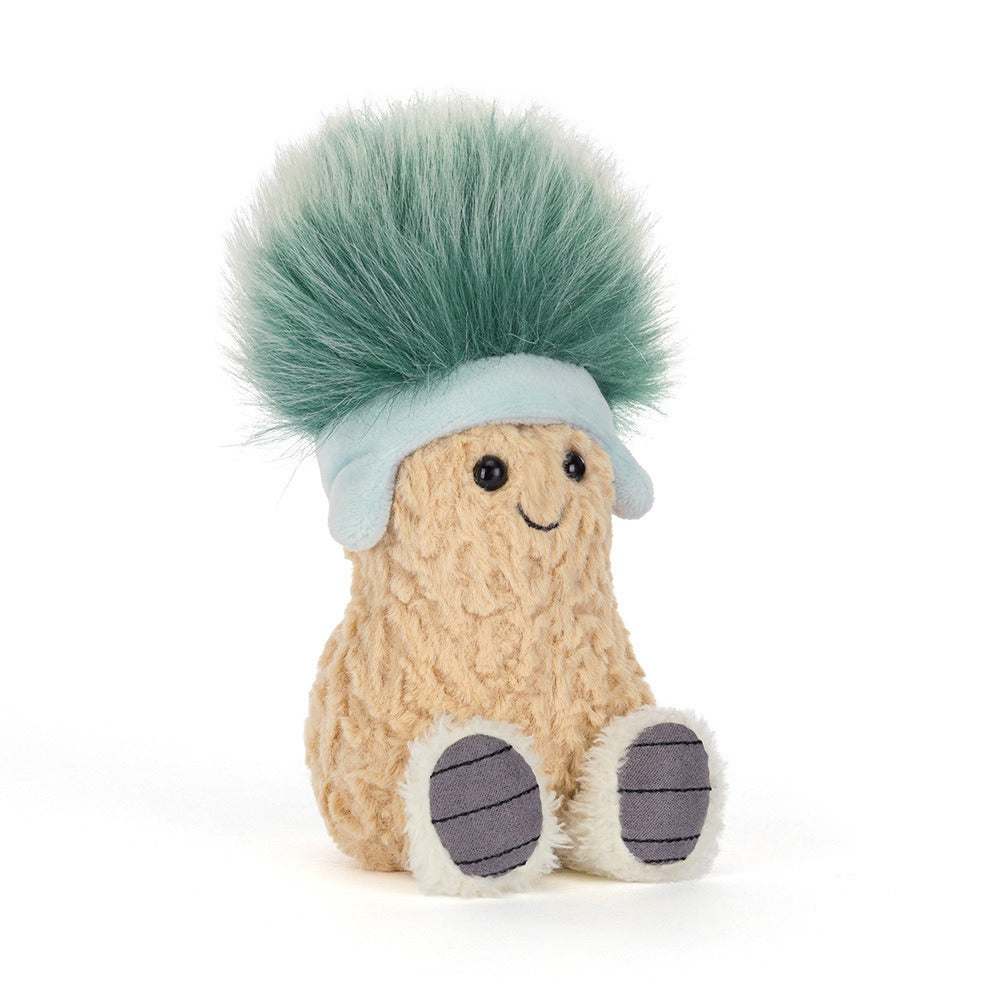 A 45 degree view of a cute plush toy shaped like a peanut with a smiling face, wearing a light blue hat topped with fluffy green hair and featuring soft beige textured body and little white feet.