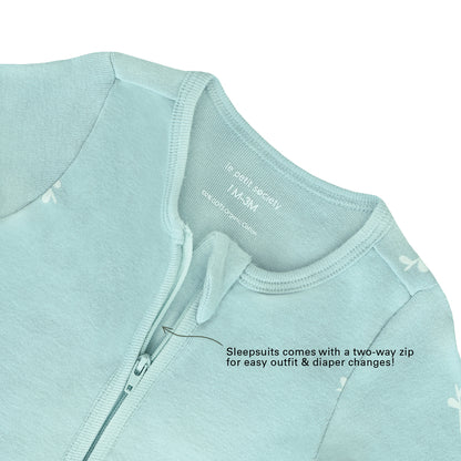 An infographic demonstrating the two-way zipper of a mint blue baby zip sleepsuit, and its function of providing an easy access to outfit and diaper changes.
