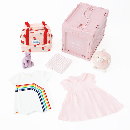 Le Petit Society's pink baby girl gift hamper containing a pink baby dress, white romper in rainbow print,  organic swaddle, pink animal plush dolls, thermal lunch bag and a collapsible storage crate.