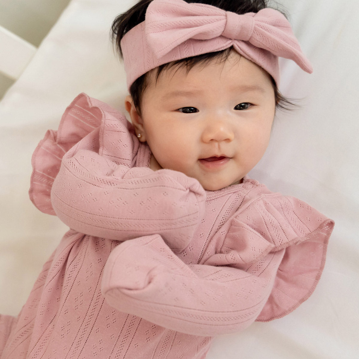 Baby Girl Long Sleeve Ruffle Romper in Plum Pointelle Cotton by Le Petit Society — image 2