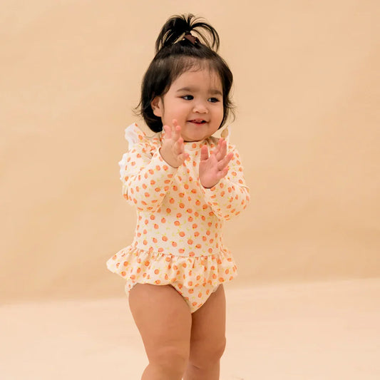 Baby Ruffle Swimsuit in Peach Print by Le Petit Society — image 2