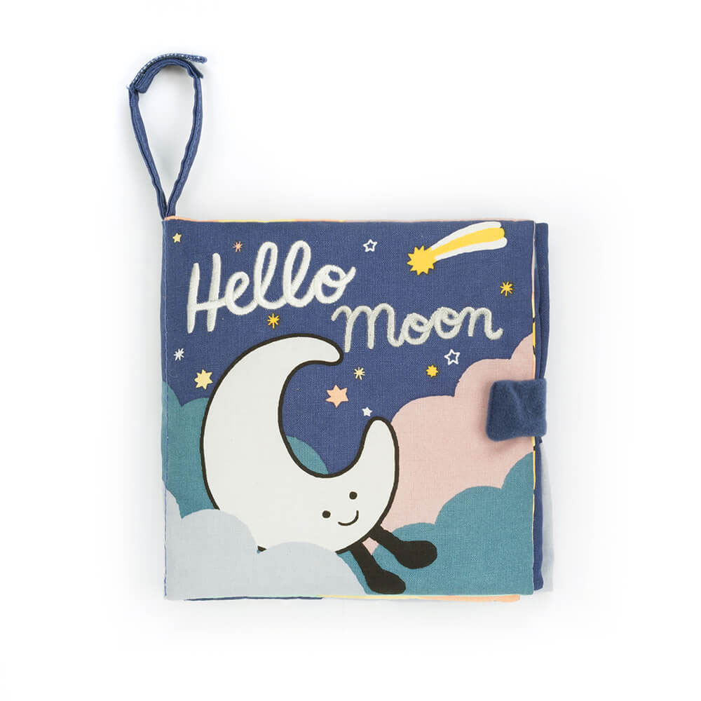 This is the soft fabric baby book "Hello Moon", featuring a crescent moon in the clouds and embroidered title on a dark sky filled with stars and a shooting star