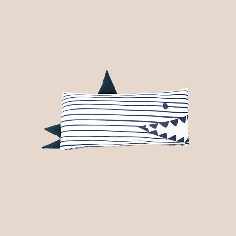 A bamboo pillow in a navy shark design for kids by Le Petit Society.