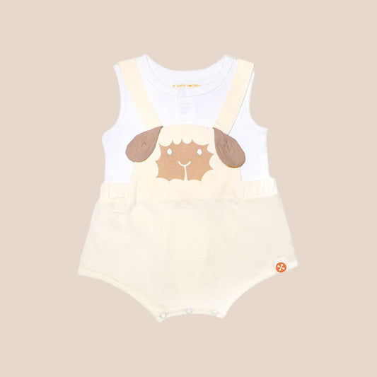 An animal-themed baby romper by Le Petit Society, featuring a sheep's face in beige at the front, complete with bottoms and cross back straps in beige over a white undershirt.
