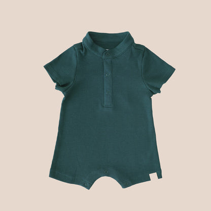 A rib knit baby romper in forest green from Le Petit Society.