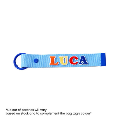 Le Petit Society's customisable blue bag tag with name patches.