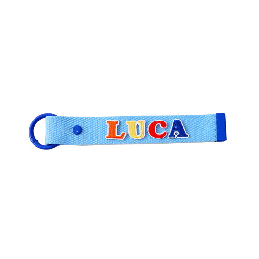 Le Petit Society's blue bag tag customised with name patches.