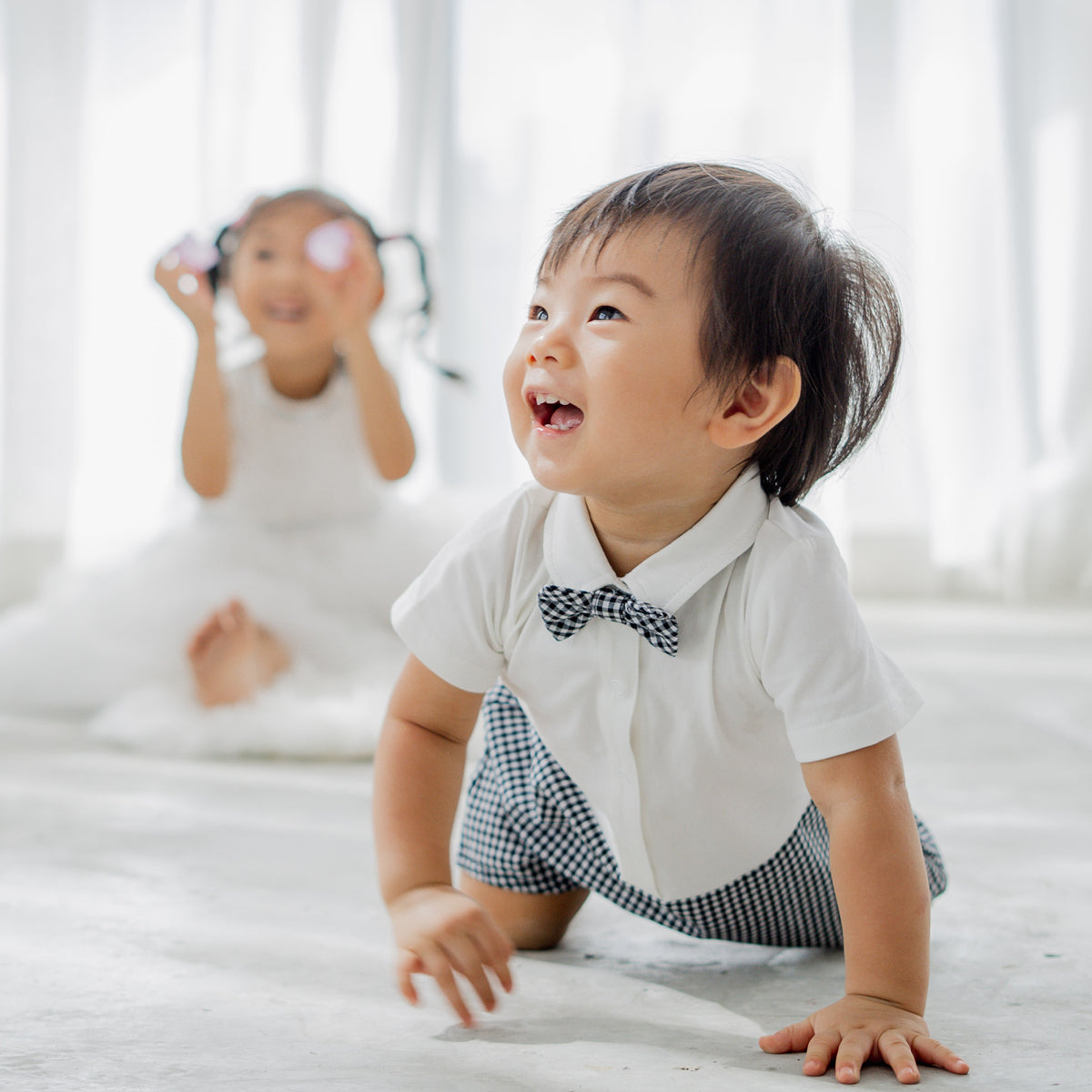 Papa & Mini - Baby Boy Bow Tie Romper in Black Gingham by Le Petit Society