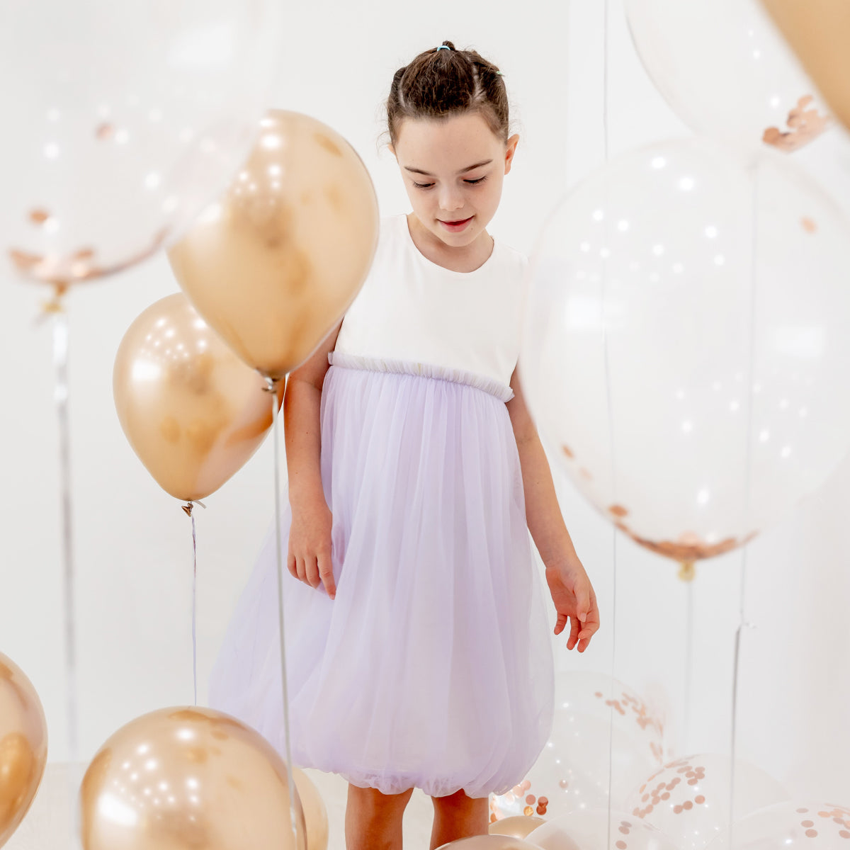 Flower girl bubble dress in lilac tulle with flutter sleeves and gold elastic waistband