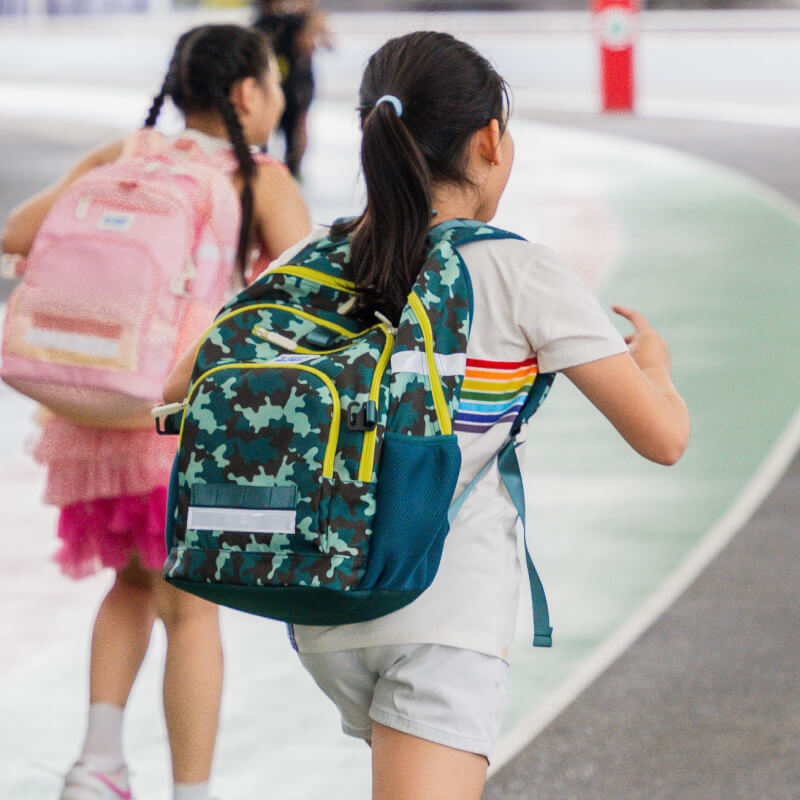 A primary school carrying the LPS kids double pocket school bag.