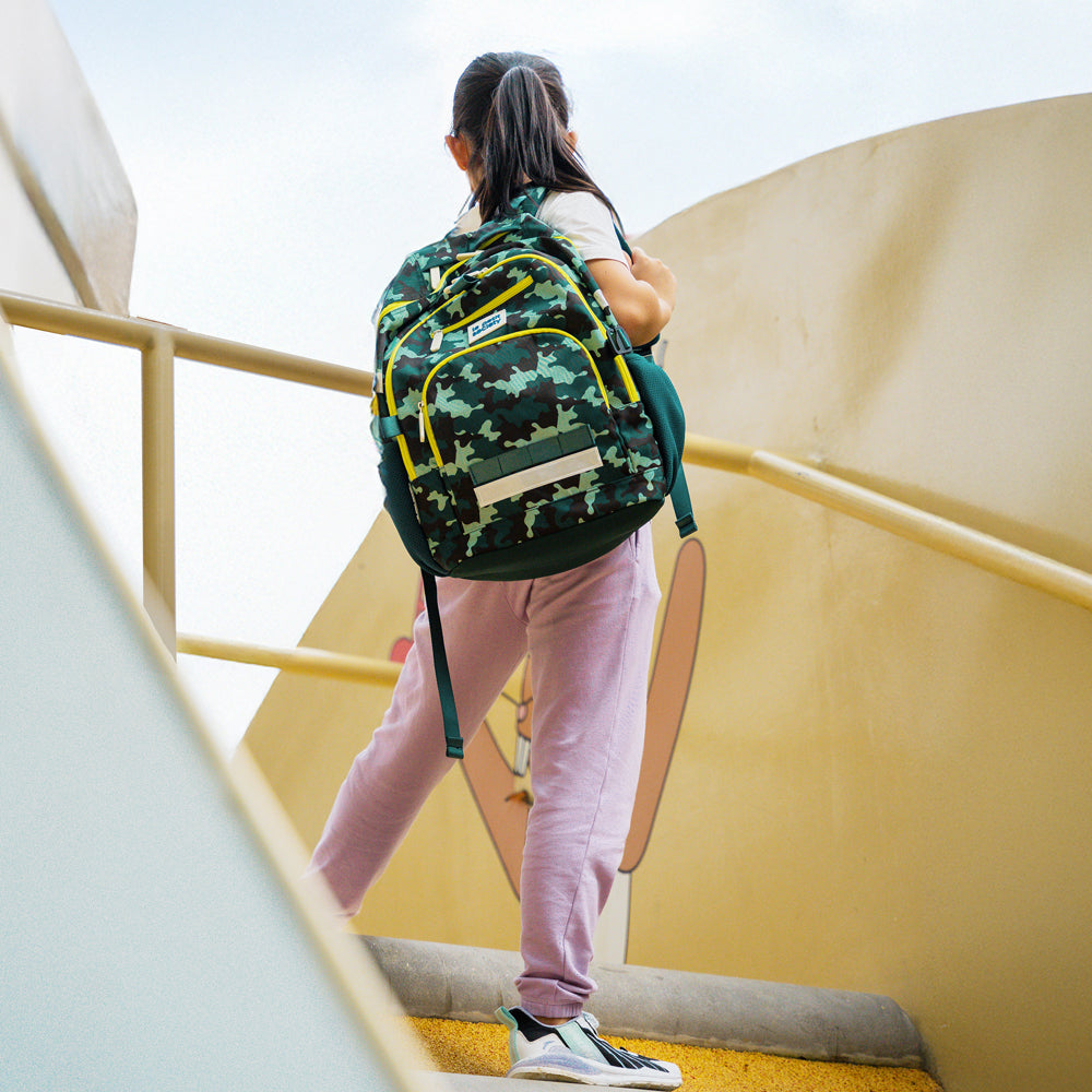 A primary school carrying the LPS kids double pocket school bag in camouflage print.