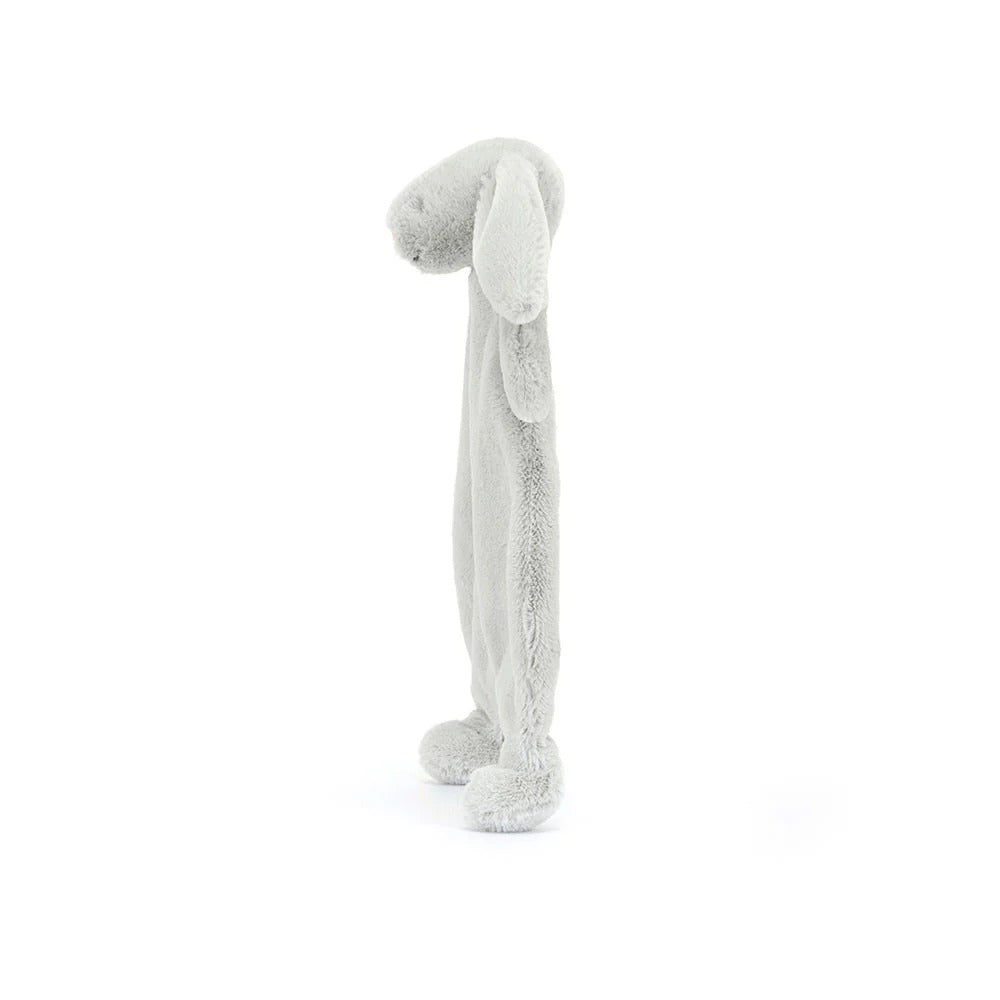A side view of a silver plush bunny comforter with long floppy ears, stitched facial features, and a flat blanket-style body with lightly padded arms and feet, positioned standing against a white background.