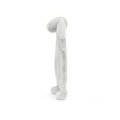 A side view of a silver plush bunny comforter with long floppy ears, stitched facial features, and a flat blanket-style body with lightly padded arms and feet, positioned standing against a white background.