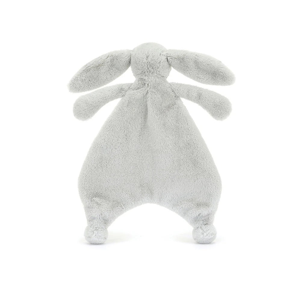 A back view of a silver plush bunny comforter with long floppy ears, stitched facial features, and a flat blanket-style body with lightly padded arms and feet, positioned standing against a white background.