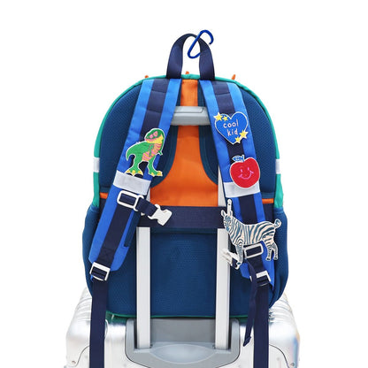 The shoulder straps of a school bag personalised with sticker patches.