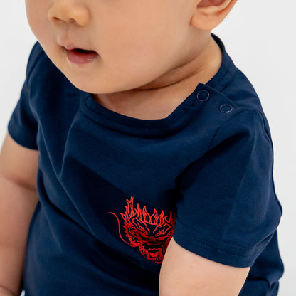 A close-up featuring the snap buttons of a baby romper in dragon print from Le Petit Society's Dragon Streetwear collection.