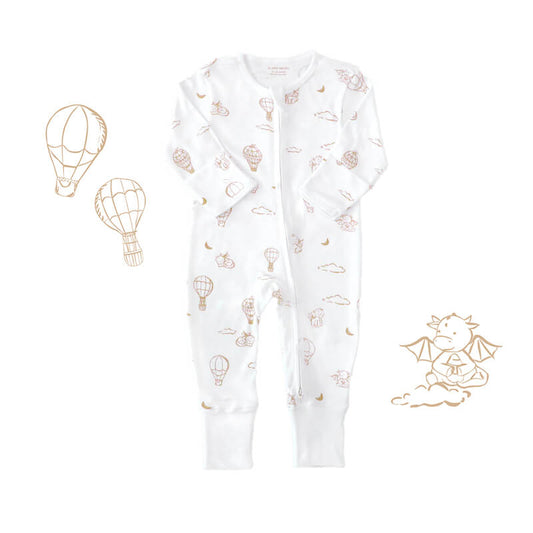 Le Petit Society's organic baby zip sleepsuit in white with a print of dragons, clouds, moons and hot air balloons. It comes foldable mittens and footies.
