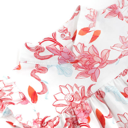 Close-up of the baby girl dress from the Le Petit Society x Sheila Sim CNY 2026 Lotus Collection. The image highlights the soft mandarin collar, gentle gathering at the bodice, and the intricate lotus print in coral, pink and light blue tones. The fabric 