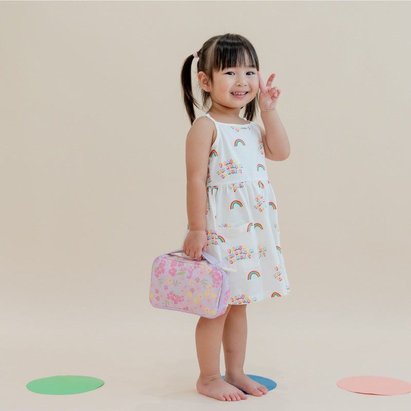A preschool girl carrying a floral purple pencil case.