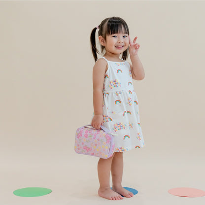 A preschool girl carrying a floral purple pencil case.