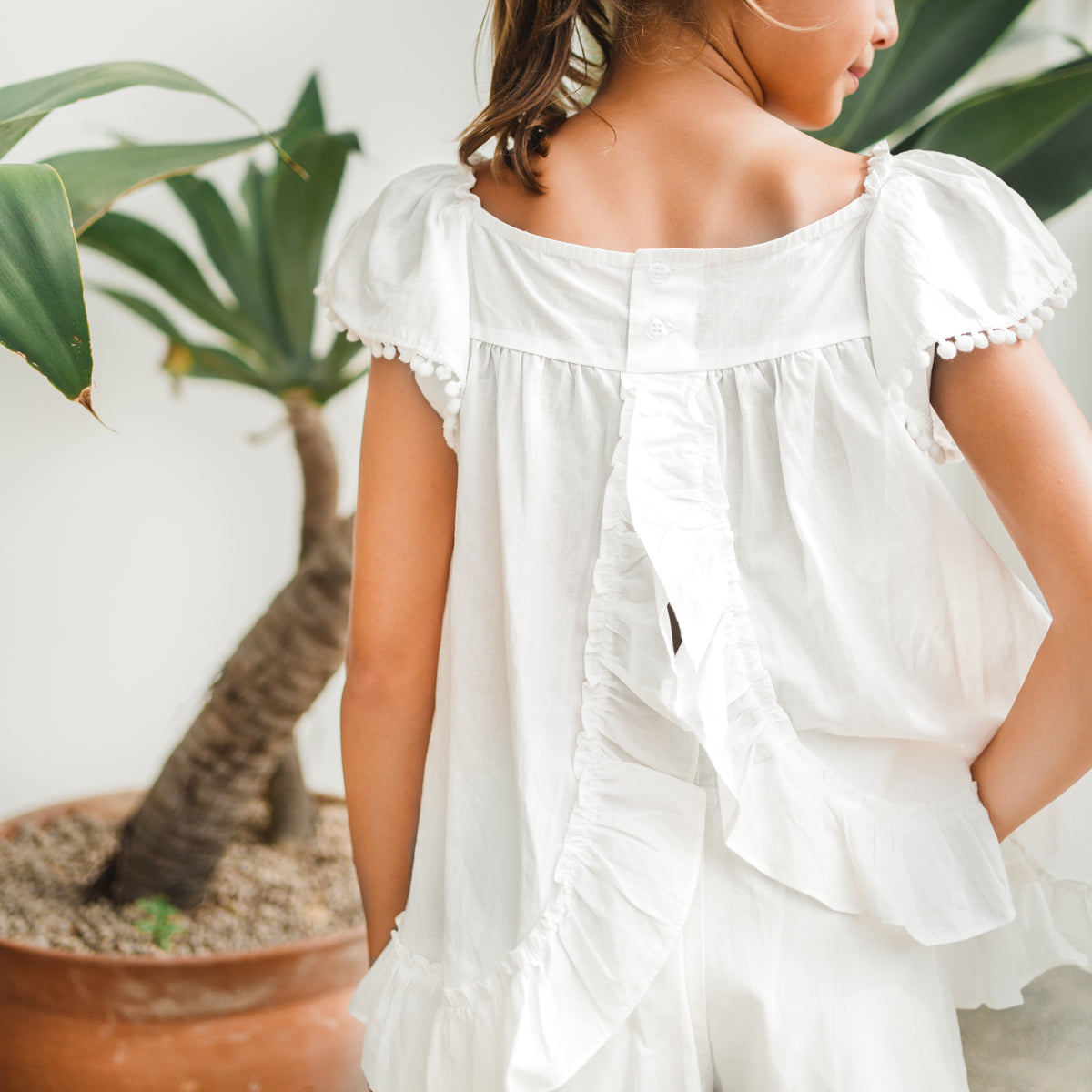 Resort Series - Girls Flutter Sleeves Baby Doll Top in White by Le Petit Society — image 15