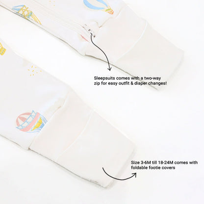 An infographic demonstrating the two-way zipper of a baby zip sleepsuit in hot air balloon print, and its function of providing an easy access to outfit and diaper changes.