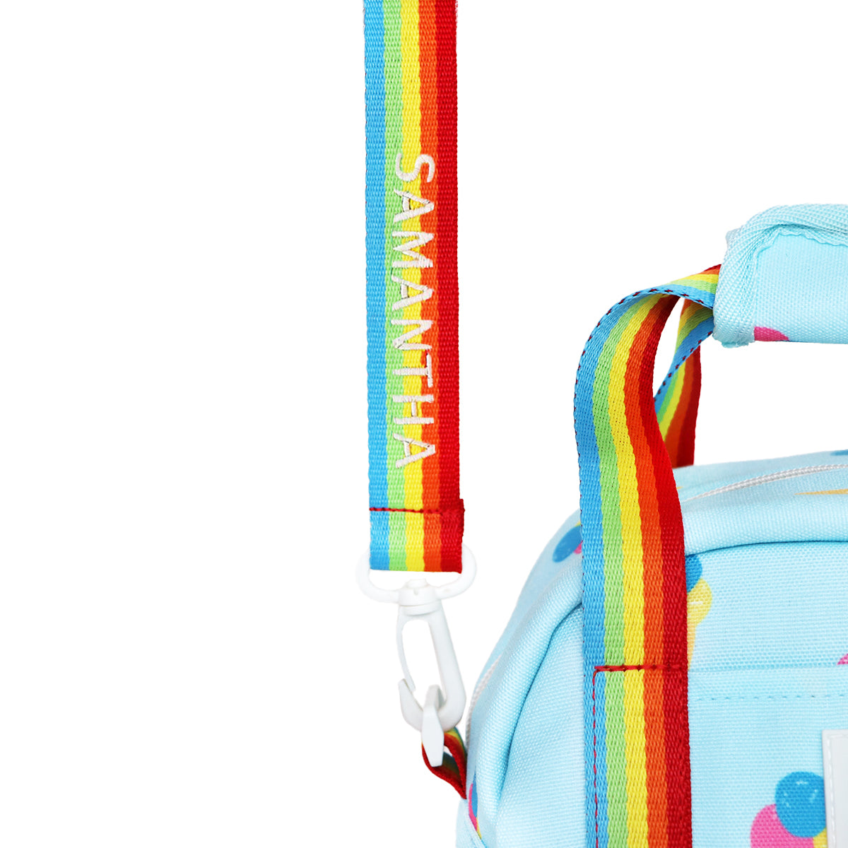 A close-up of a personalised name embroidery on a rainbow bag strap of Le Petit Society's thermal lunch bag.