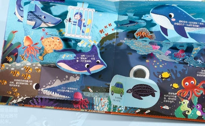Interactive ocean-themed 3D pop-up book page featuring colorful marine life, including sharks, whales, stingrays, octopuses, and a diver in a cage. Designed to engage children with fun facts and flaps, ideal for early STEM learning and ocean exploration.