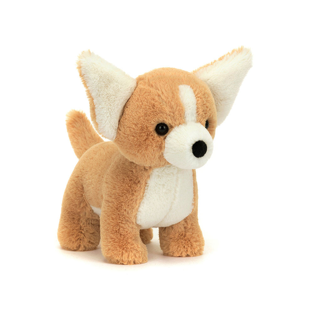 A front view of a chihuahua standing plush with soft tan fur, a white belly, face, and ears. It has a small white stripe on its forehead, large upright ears, and black button eyes and nose