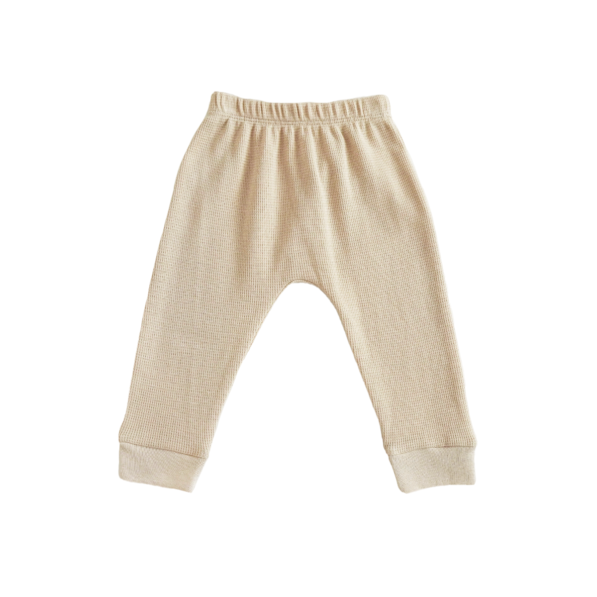A pair of organic baby leggings in beige by Le Petit Society.