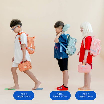 Three primary school kids carrying school bags and pencil cases by Le Petit Society.