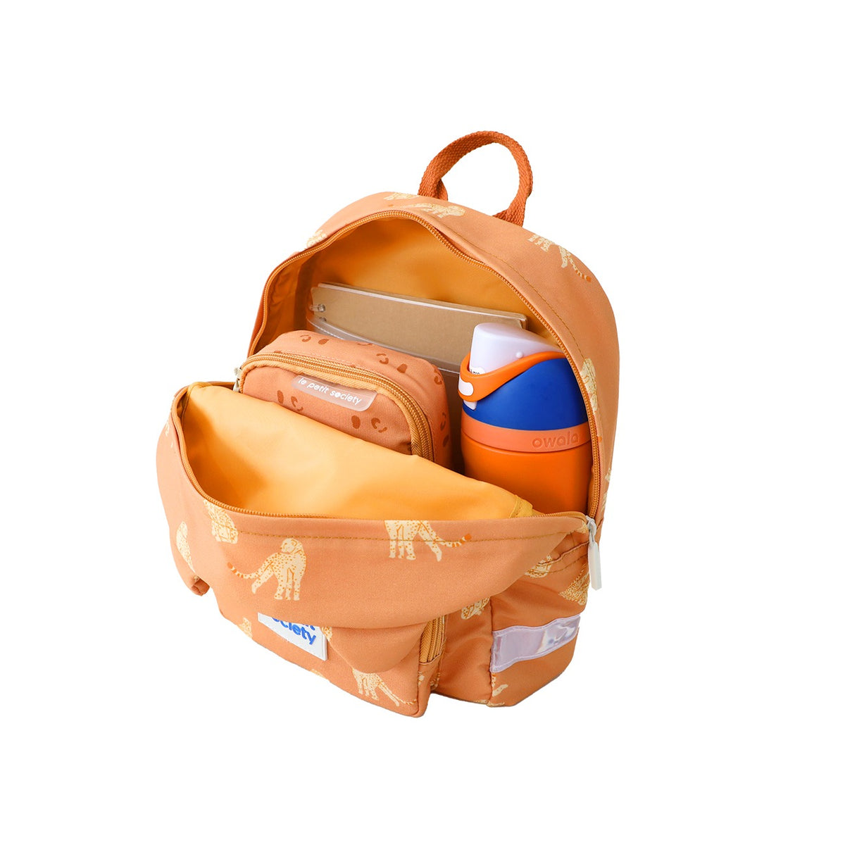 A water bottle, pencil case and notebook being stored in an orange preschool bag.