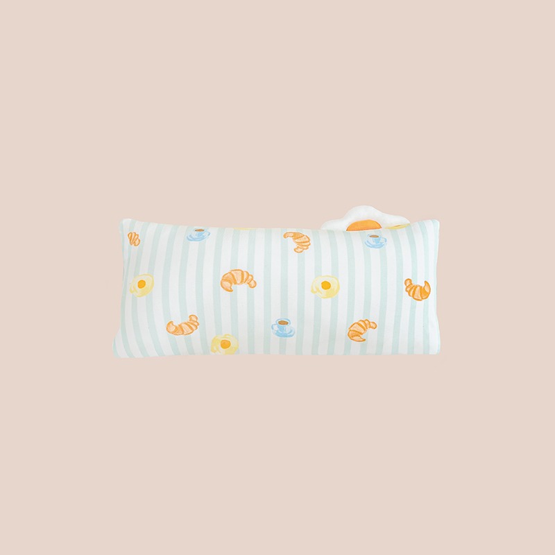 A kids' bamboo pillow with green stripes and a print of breakfast food by Le Petit Society.