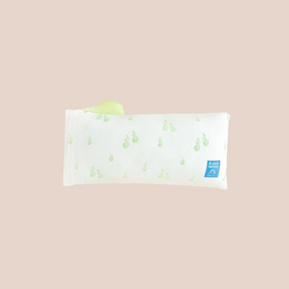 The back of a kids' mini pillow from Le Petit Society, featuring a print of green pears.