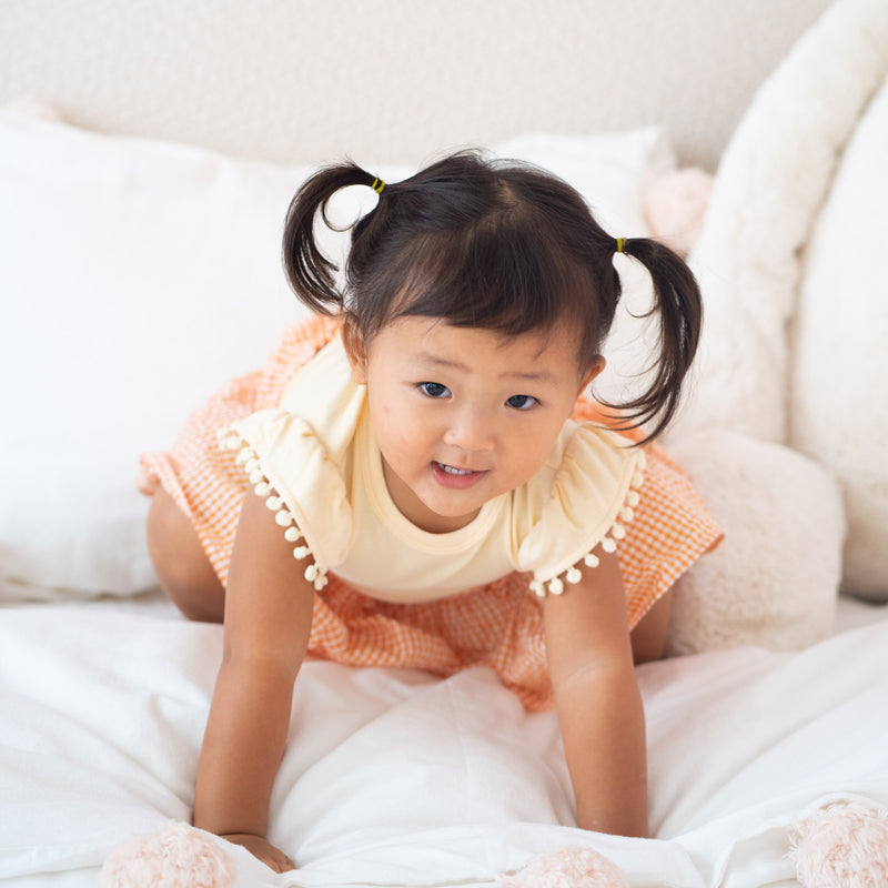 Resort Series - Girls Top with Pom Pom Sleeves in Peach by Le Petit Society