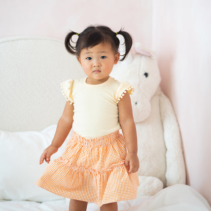 Resort Series - Girls Top with Pom Pom Sleeves in Peach by Le Petit Society — image 2
