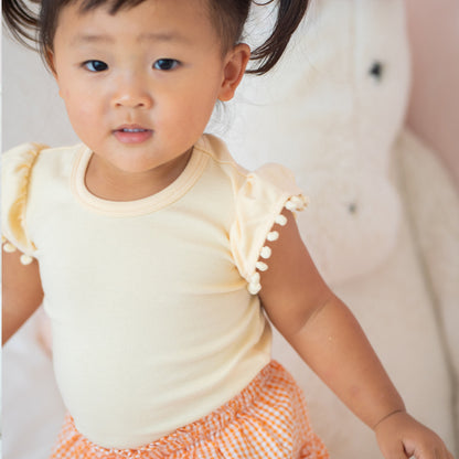 Resort Series - Girls Top with Pom Pom Sleeves in Peach by Le Petit Society — image 3