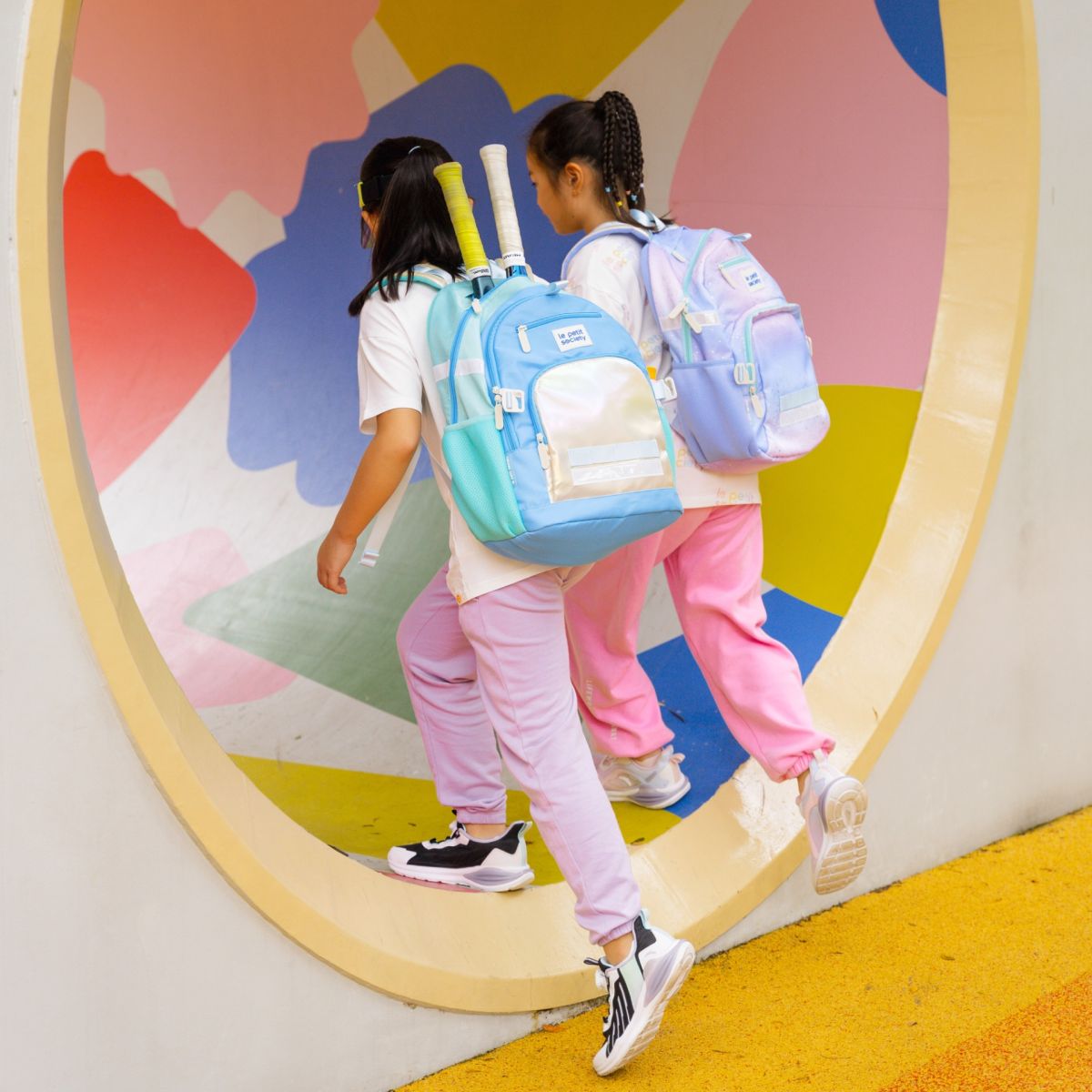 Two primary school girls carrying the single and double pocket school bags by Le Petit Soi