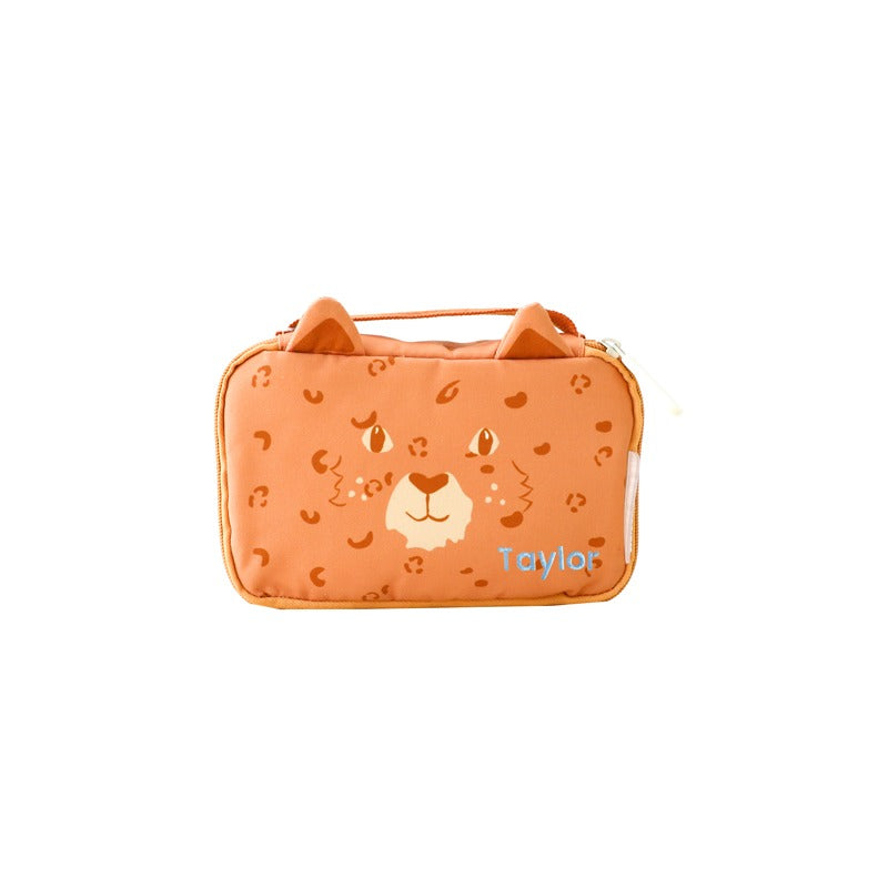 An orange tiger print pencil case with ears and custom name embroidery.