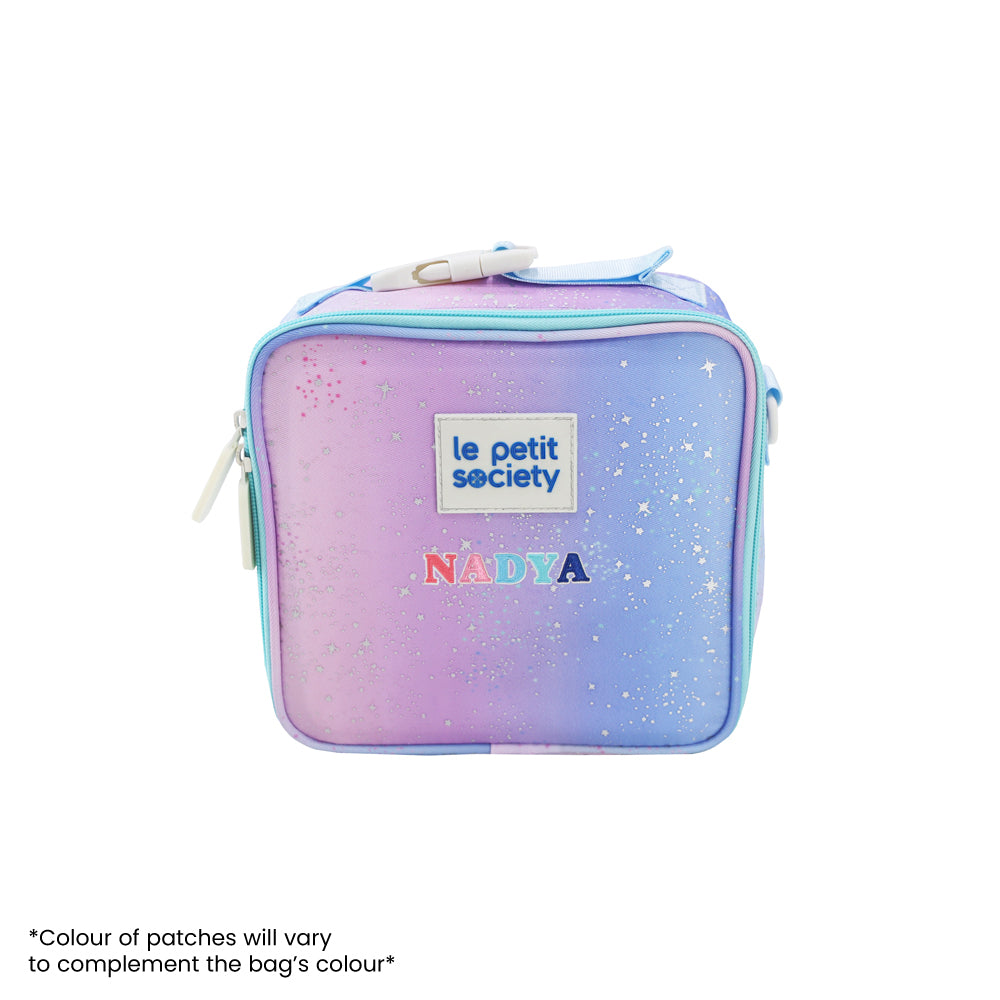 A thermal lunch bag in an ombre blue and pink colour and personalised with name patches.