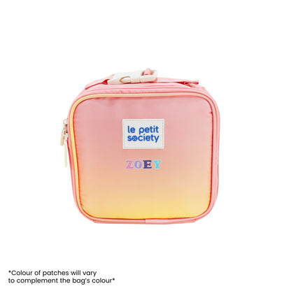 An ombre, pink and yellow thermal mini lunch bag with personalised name patches.