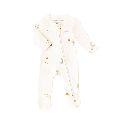 A baby organic zip sleepsuit with foldable mittens and footies by Le Petit Society, featuring a print of moon and stars over a cream base. 